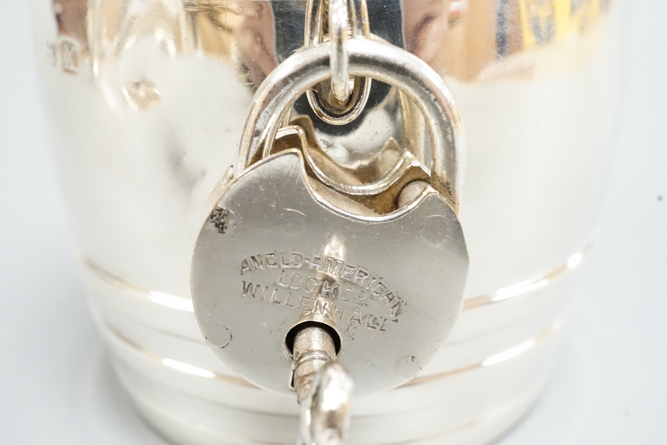 A George V silver barrel money box, with padlock & key, William Neale Ltd?, Birmingham, 1922, height 67mm.